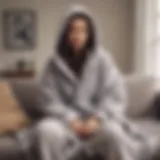 Cozy blanket hoodie draped over a modern couch