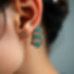 A close-up view of intricate cartilage earrings showcasing unique designs and materials.