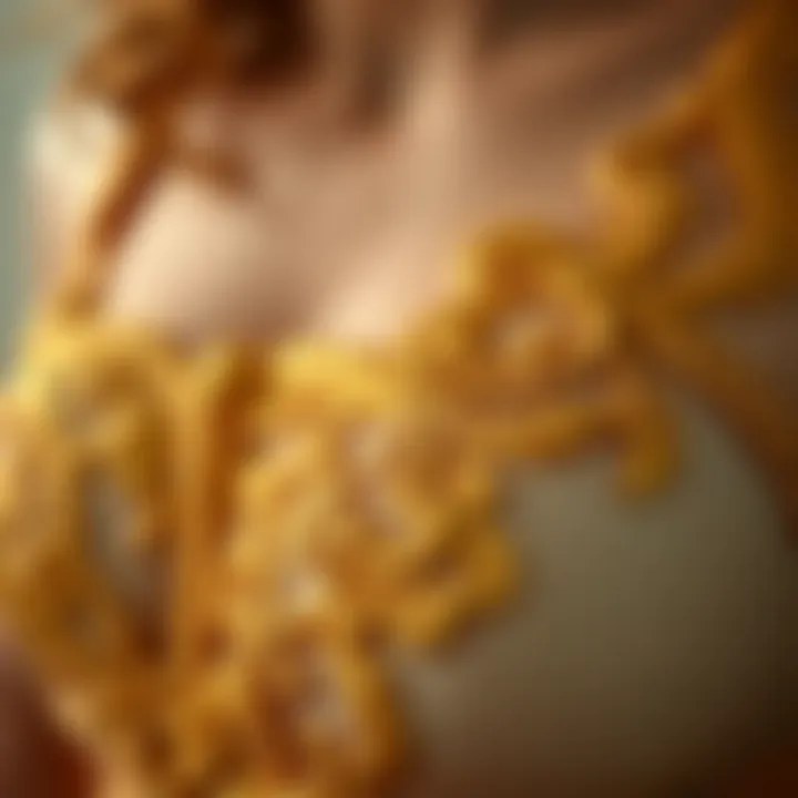 A close-up of intricate gold embroidery on delicate lingerie fabric