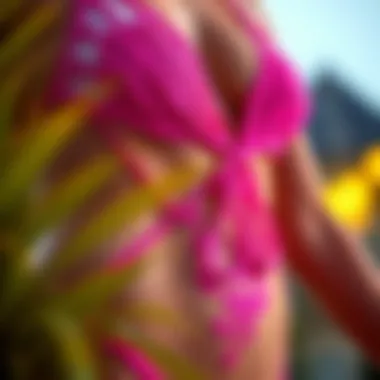 Close-up of the intricate design details and fabric texture of a neon pink one piece swimsuit