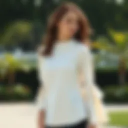 Elegant white blouse featuring bell sleeves in a serene outdoor setting