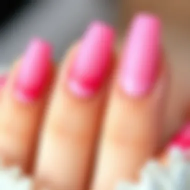 A close-up of beautifully crafted pink ombre glue-on nails showcasing intricate designs.